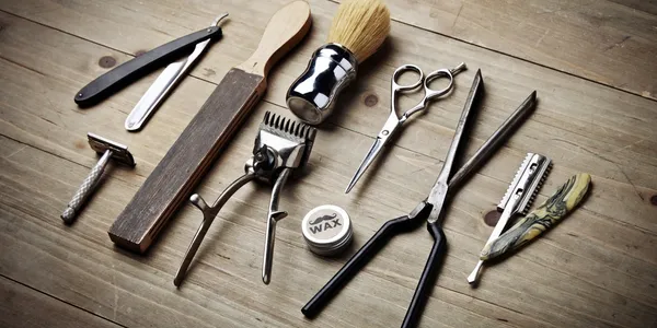Classic barber tools — razors, shears, clippers, and brush